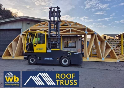 Forklift lifting wooden truss structure