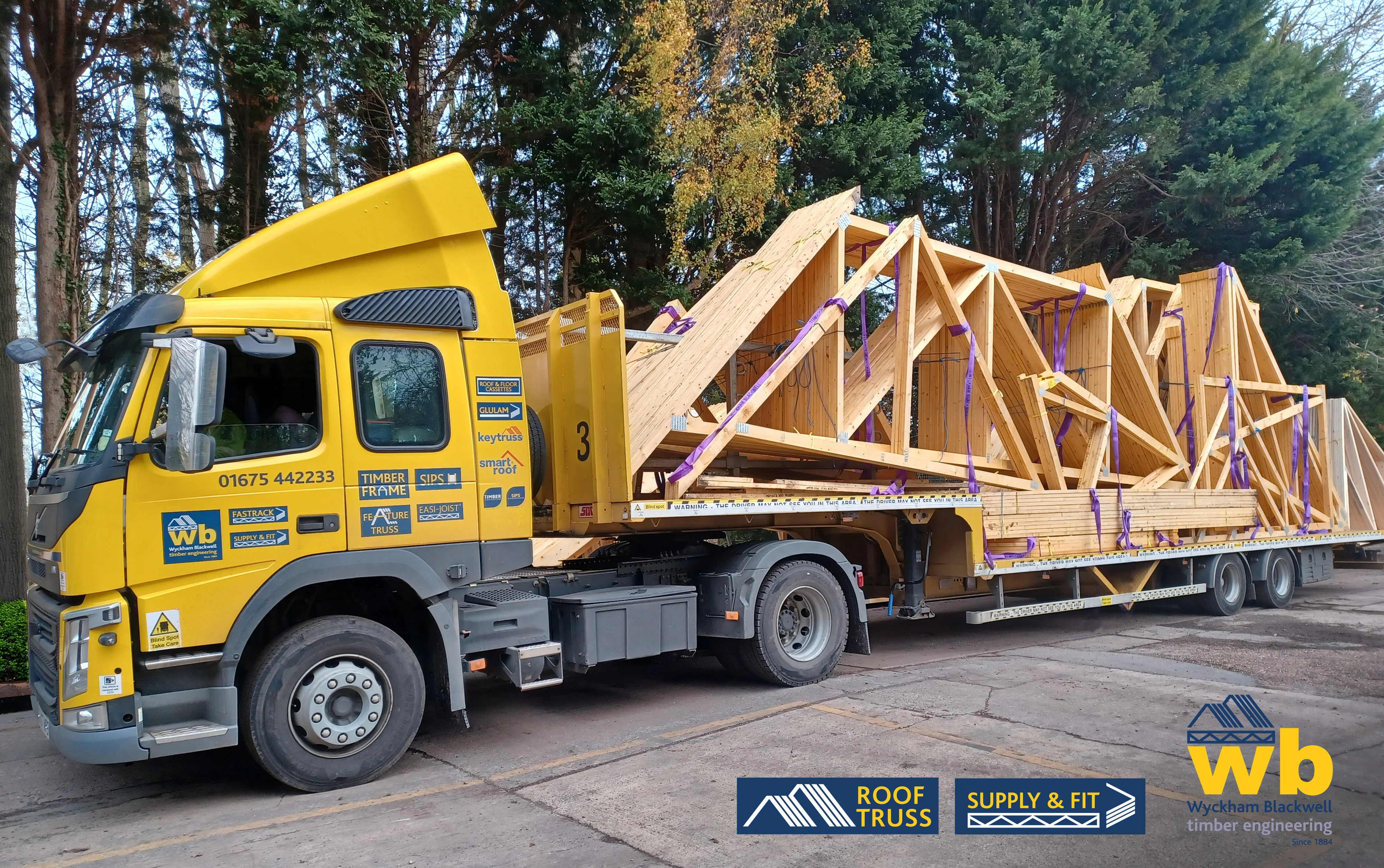 A WB Lorry with a Roof truss secured on it.