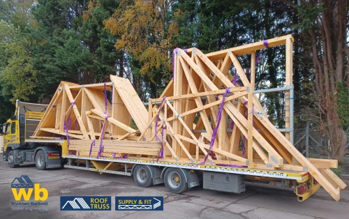A WB Lorry with a Roof truss secured on it.