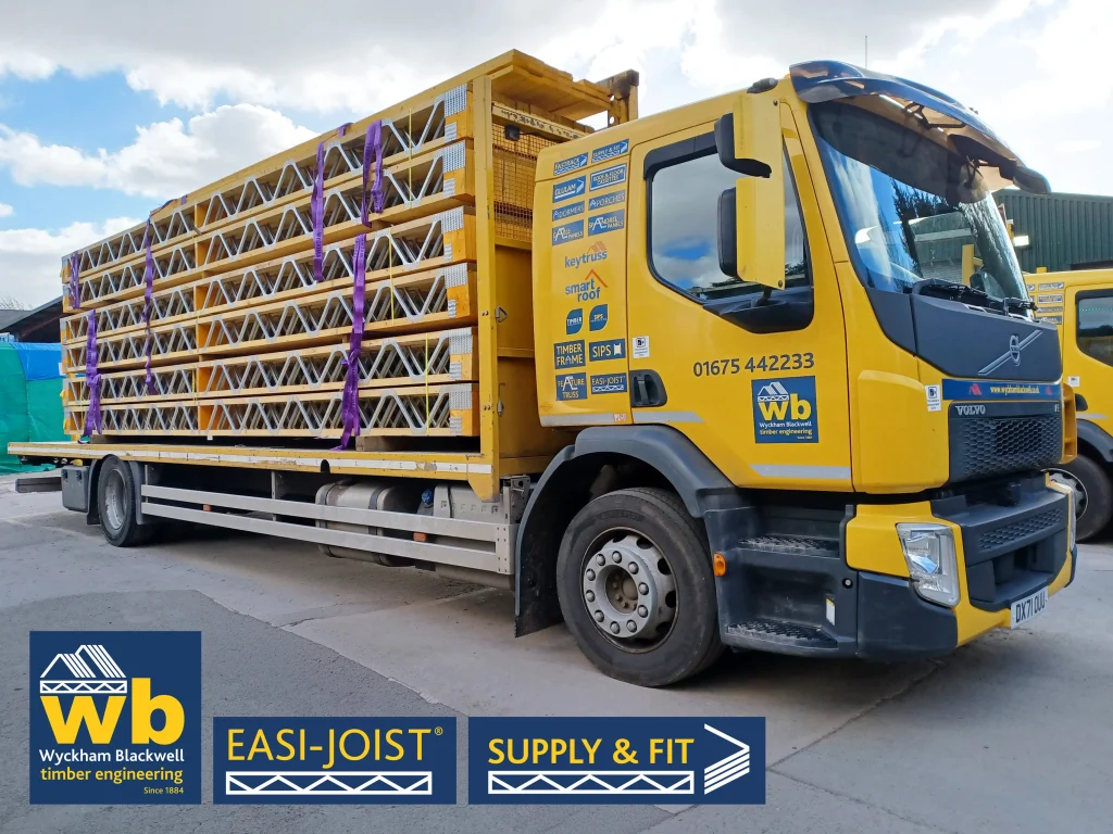Side angle of a yellow Wyckham Blackwell branded lorry with a full load of easi-joist metal web joists