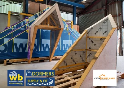 Two Wyckham Blackwell timber Dormer frames on pallets inside a workshop.